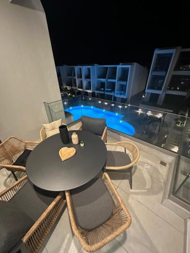 a black table and chairs on a balcony at Artion Suites Nikiti in Nikiti