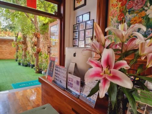 a vase with a pink flower on a counter at Maison Saiko Angkor Boutique in Siem Reap