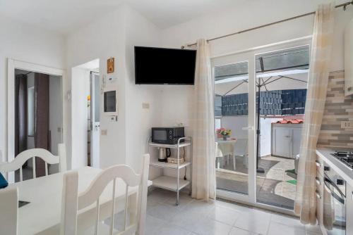 a living room with a flat screen tv on the wall at CASA VERDE Inn in Ischia