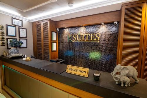 a hotel reception counter with a sign on the wall at Şişli Luxury K Suites Hotel in Istanbul