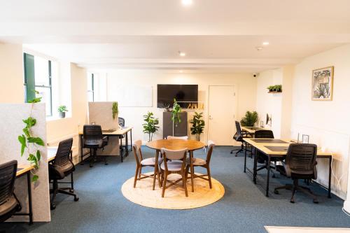 an office with tables and chairs and a tv at YHA Blue Mountains Katoomba in Katoomba