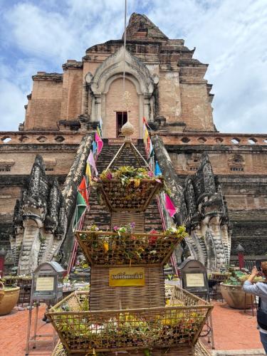 a display of flowers in baskets in front of a building at Laph Kham House in Chiang Mai