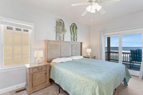 a bedroom with a bed and a view of the ocean at 8046 - Sun Runner in Rodanthe