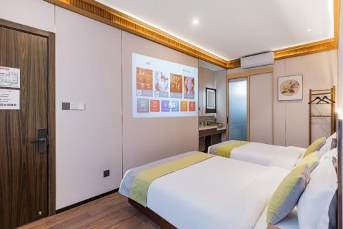 a hotel room with two beds and a bathroom at Beijing city center - Courtyard house hotel located in an ancient Hutong, near the Forbidden City,experience the lifestyle of old Beijing in the exquisite Chinese-style courtyard in Beijing