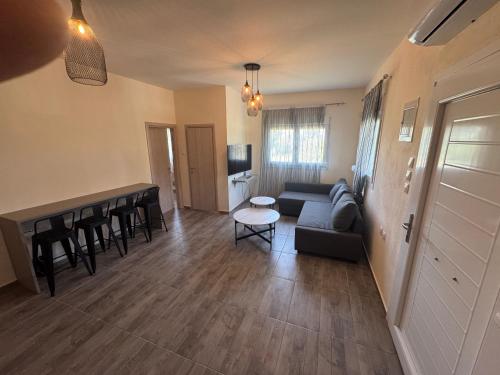 a living room with a couch and a table at Michalis Home in Nea Kalikratia