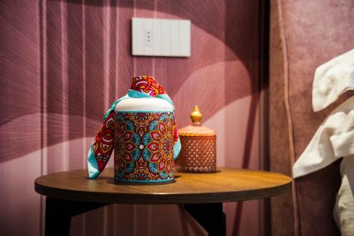 a colorful mug on a table with a candle at Colle Serrano Relais & SPA in Ripatransone