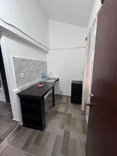 a room with a desk and a table in a room at Departamento mini Huatulco in Santa Cruz Huatulco
