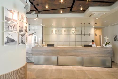 a woman sits at the counter of a salon at Nautilus Family Hotel in Pesaro