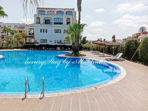 a villa with a swimming pool in a resort at LuxuryStay by Al Amir in Martil