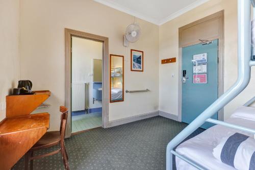 a bedroom with a bunk bed and a mirror at YHA Blue Mountains Katoomba in Katoomba