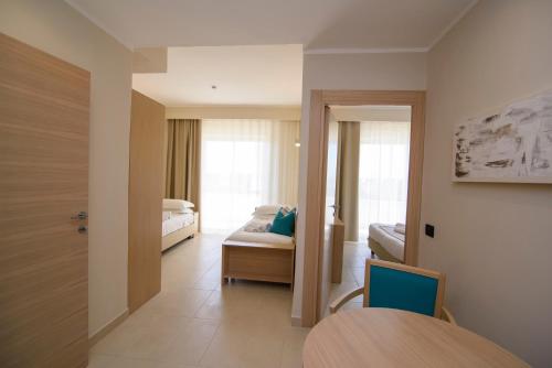 a room with a bedroom with a bed and a table at Grand Hotel President in Siderno Marina