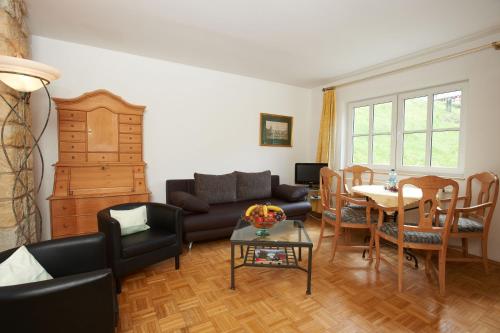 a living room with a couch and a table at Apartments Erbgericht in Bad Schandau