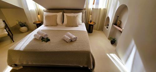 a bedroom with a bed with two towels on it at C a s a B e a s t in Split