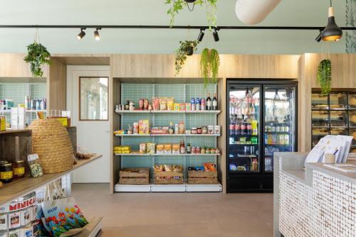 a grocery store with shelves of food and drinks at Duinresort Dunimar in Noordwijkerhout