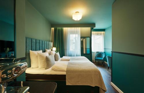 a hotel room with a large bed with white pillows at WIDE Hotel in Copenhagen
