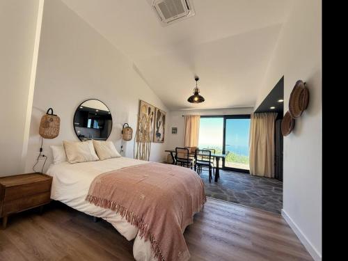 a bedroom with a large bed with a view of the ocean at V.V. Verde Amanecer 5 in Las Casas