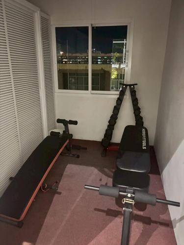 a gym with two tread machines and a window at Royal Prince Resort Pattaya in Pattaya South