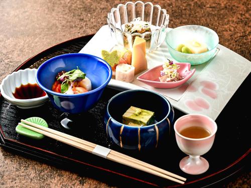 a tray with bowls of food and chopsticks on a table at Shin Kadoya in Atami
