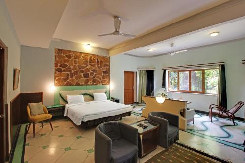 a bedroom with a bed and a living room at Hotel Inn Season - Art Deco Heritage Hotel in Jodhpur in Jodhpur