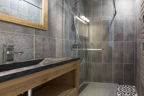 a bathroom with a sink and a shower at MIA in La Noue