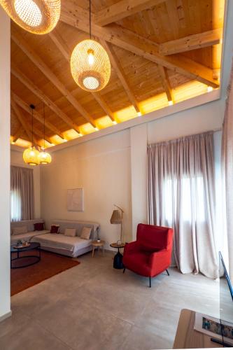 a living room with a couch and a red chair at Scalma Villas in Skaloma
