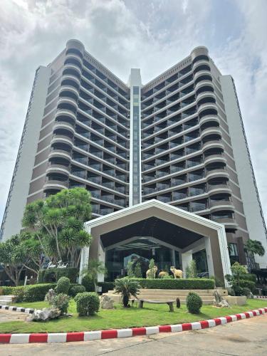 a large building with a park in front of it at First Pacific Cirrus in Pattaya Central