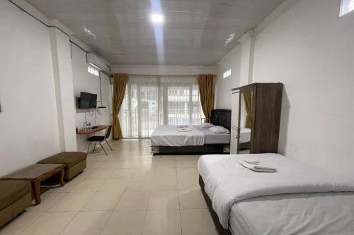 Postel nebo postele na pokoji v ubytování Agave Hotel Siantar