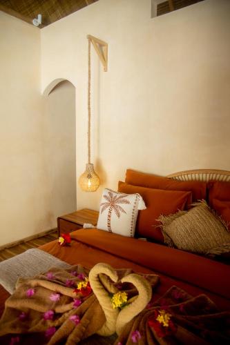 a living room with a couch with flowers on the floor at Villa Keluarga in Gili Air