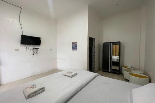 Katil atau katil-katil dalam bilik di Agave Hotel Siantar