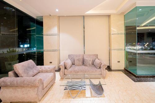 a living room with two couches and a coffee table at Royal Prince Resort Pattaya in Pattaya South