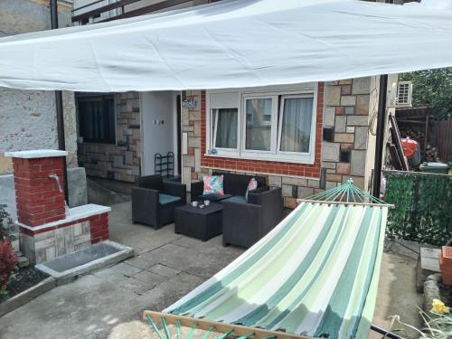 a patio with a hammock in front of a house at Family House in Golubac