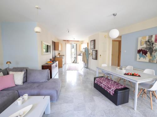 a living room with a couch and a table at Mediterranean Escape - Coastal 2-Bedroom Apartment Limassol in Limassol