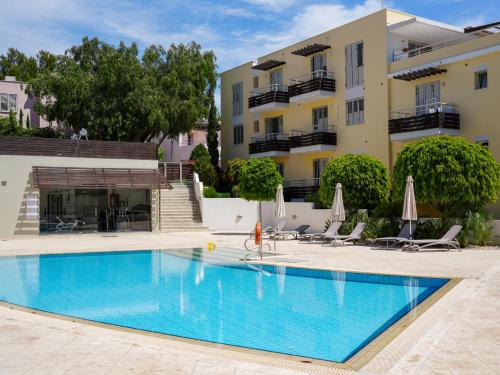a swimming pool in front of a building at Mediterranean Escape - Coastal 2-Bedroom Apartment Limassol in Limassol