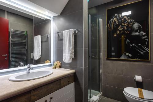 a bathroom with a sink and a glass shower at Sardegna é - BApartments in Olbia