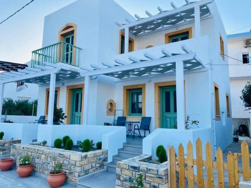 a white house with a pergola at Sophia's Apartments - Lipsi Thyme in Lipsoi