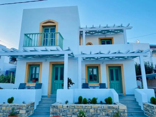 a white house with blue doors and stairs at Sophia's Apartments - Lipsi Thyme in Lipsoi
