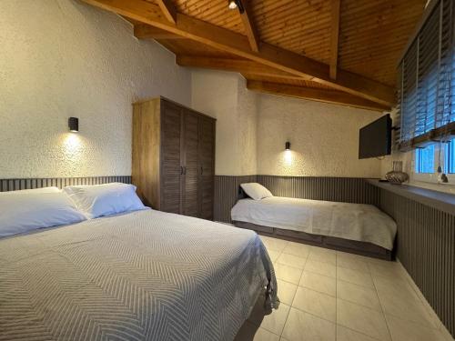 a bedroom with two beds and a tv in it at Paris sea view apartments in Platamonas