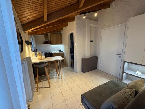 a living room and kitchen with a couch and a table at Paris sea view apartments in Platamonas