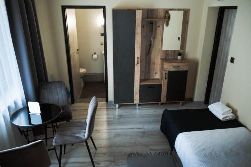 a bedroom with a bed and a table and chairs at SergJuli Villa in Plavecký Štvrtok