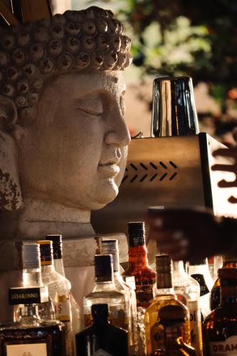 a statue of a head with bottles of alcohol at BLACK AMBER BOUTIQUE HOTEL in Lampi