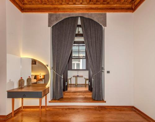 an archway in a room with a table and a desk at Elmira Pera Hotel & - Special Class in Istanbul