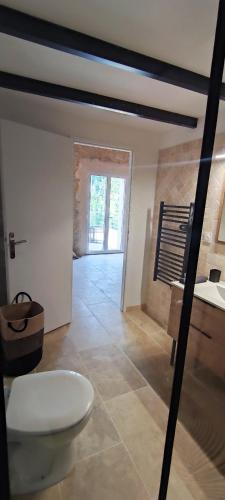 a bathroom with a toilet in a room at Au coeur du Gard in Saint-Bauzély