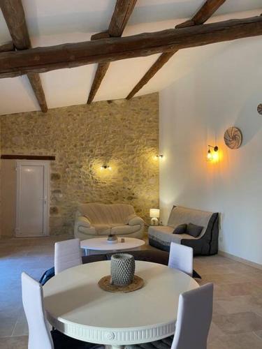 a living room with a table and chairs at Au coeur du Gard in Saint-Bauzély