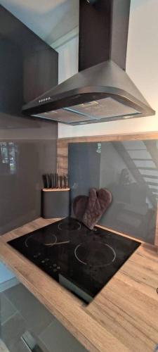 a kitchen with a stove top oven in a kitchen at Au coeur du Gard in Saint-Bauzély