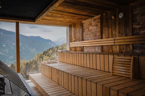 a room with a balcony with a view of the mountains at Puitalm Apartments & SPA by Peak Stay in Arzl im Pitztal