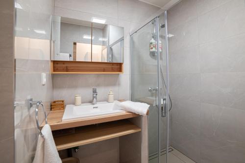 a bathroom with a sink and a shower at NEW! Sea View studio - Beachfront living in Cannes, Boulevard du Midi - Nouveau! Studio Vue mer, face à la plage, les pieds dans l'eau in Cannes