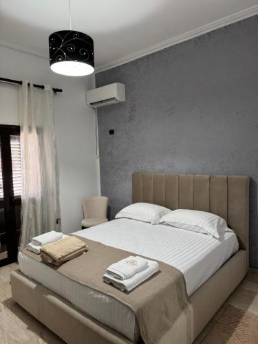 a bedroom with a large bed with towels on it at Dapaj Luxury Residence in Vlorë