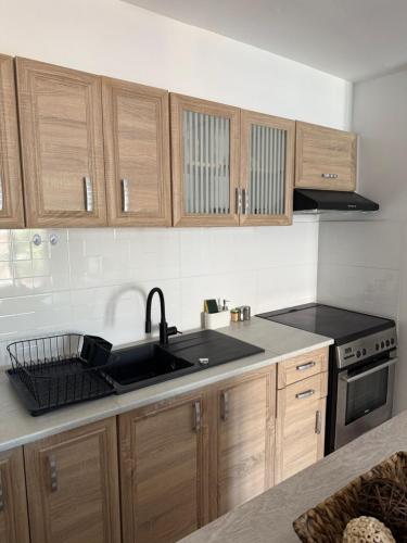 a kitchen with a sink and a stove and cabinets at The Chalkida Nook Central Spot in Chalkida