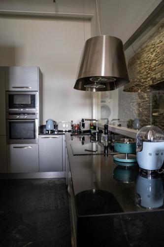 a kitchen with a counter with a sink and a stove at Casa Amici - Luxe in Cadaqués in Cadaqués