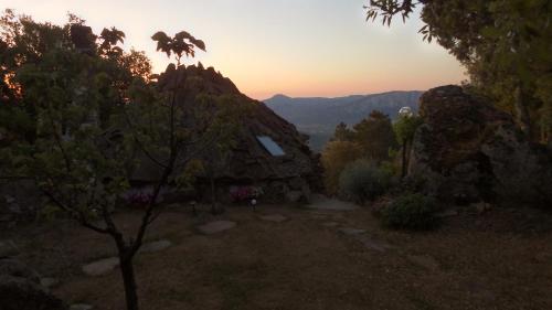 a cabin in the mountains with the sunset in the background at Rifugio Ortobene in Nuoro